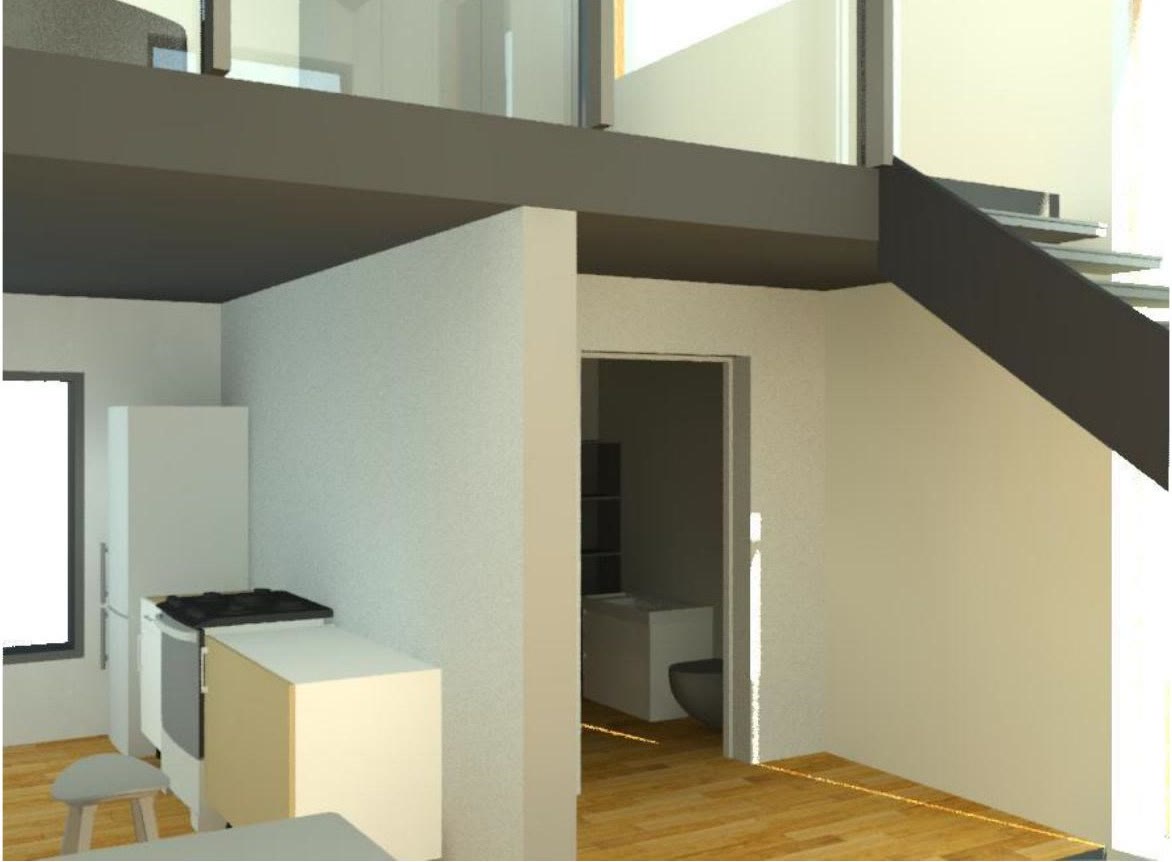 The kitchen under the mezzanine soffit, looking through to the hall beyond