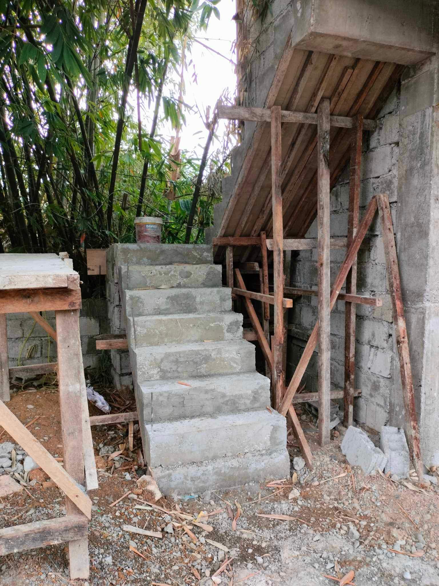 The cast concrete stair with its timber formwork and shoring still in place