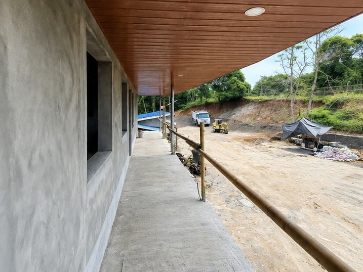 The rendered walkway with its timber lined soffit running the length of the elevation