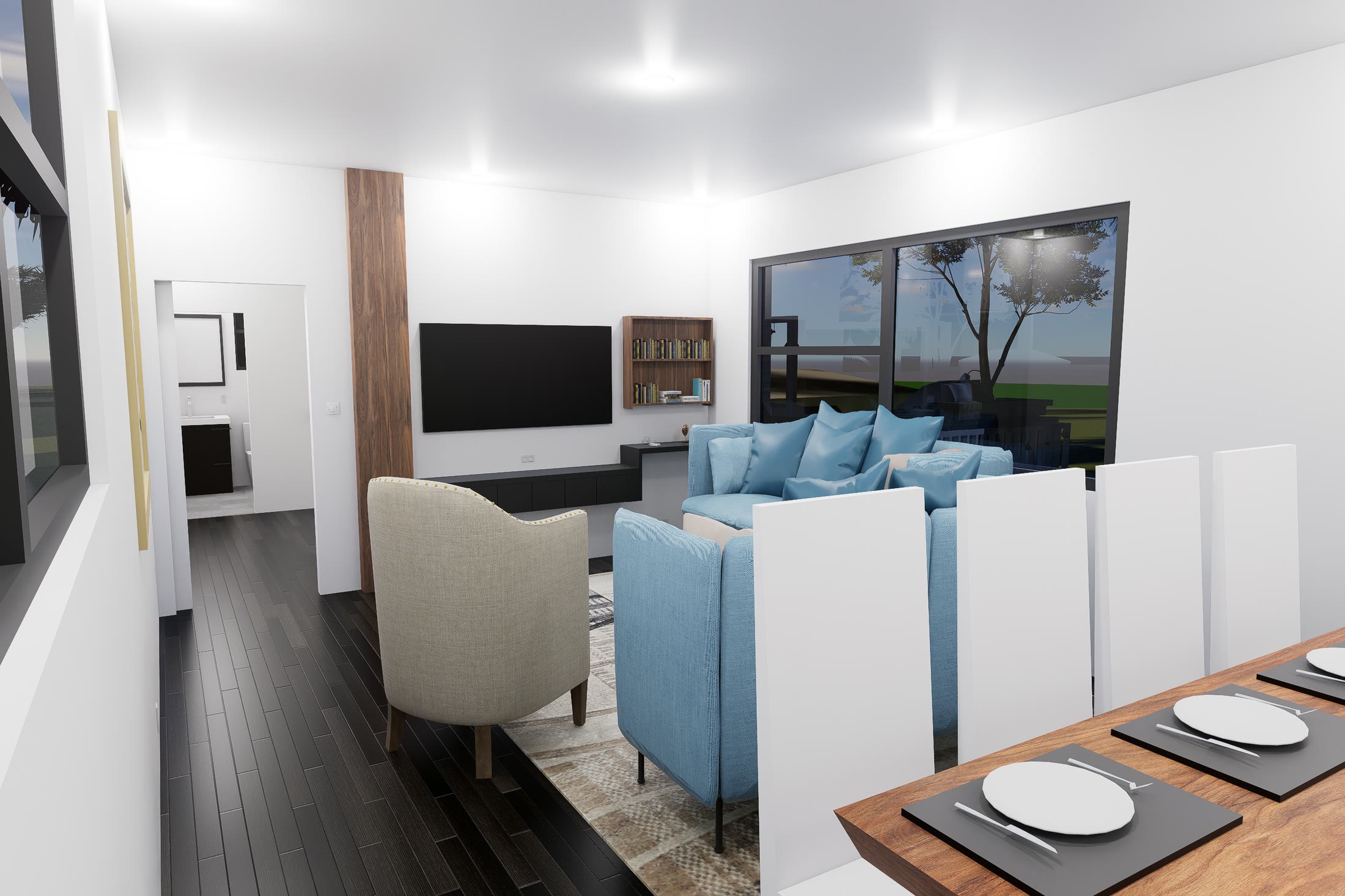 The living area with blue upholstered seating and the dining table in the foreground