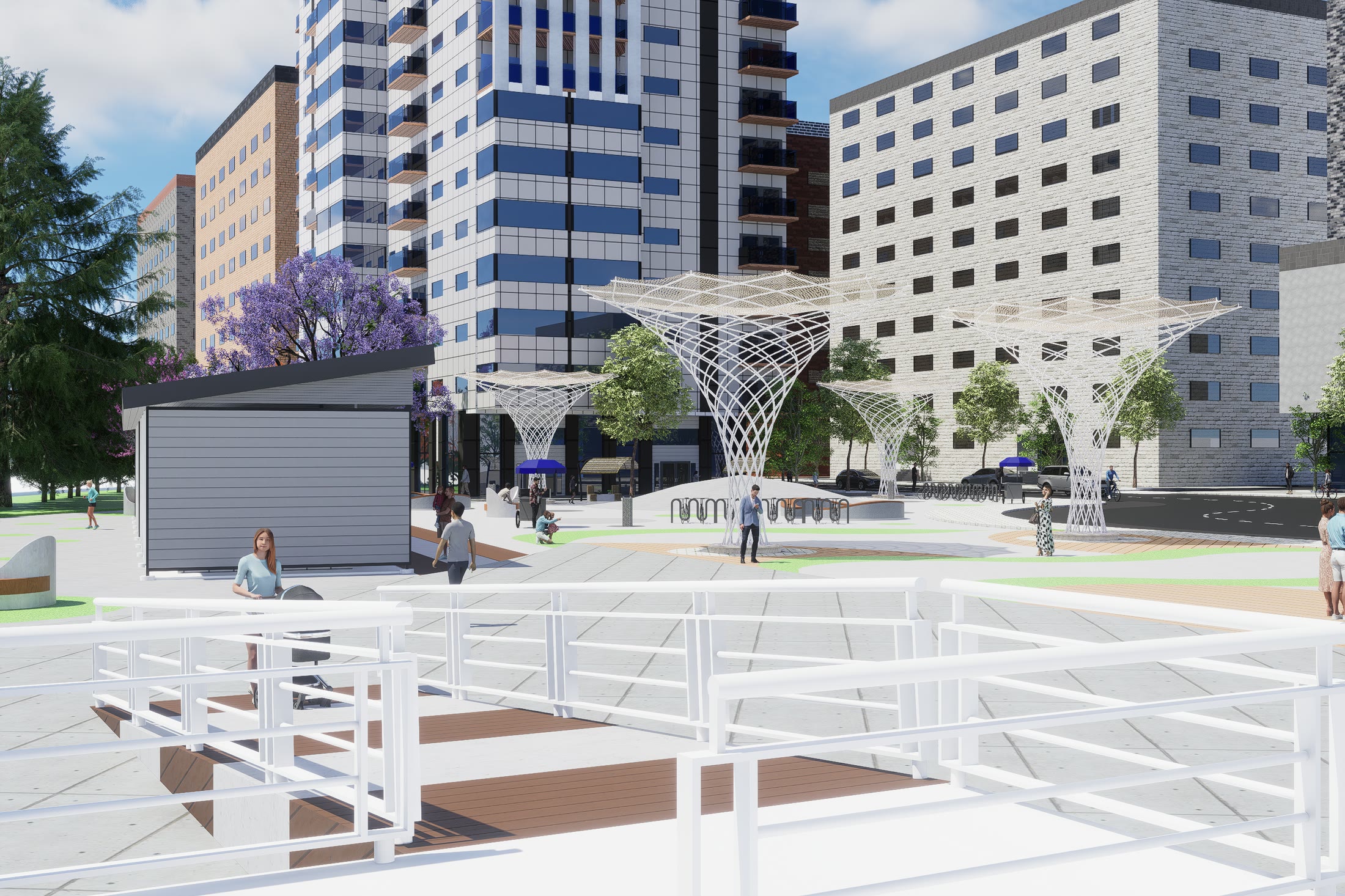 The square under the canopies with stepped terraces and seating, the blocks rising behind