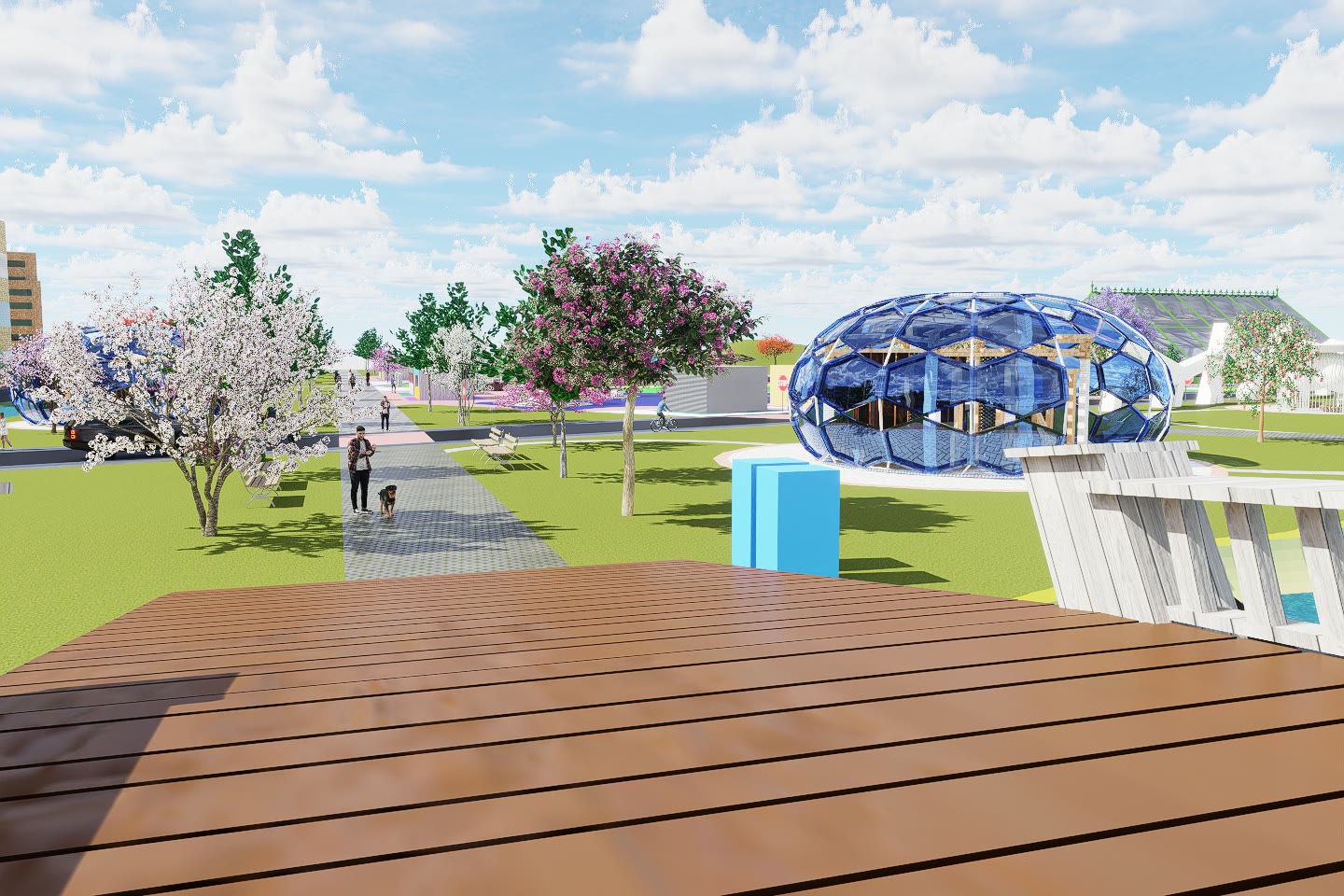 The faceted blue Arch-Flora pavilion seen across the timber deck, with blossoming trees around it