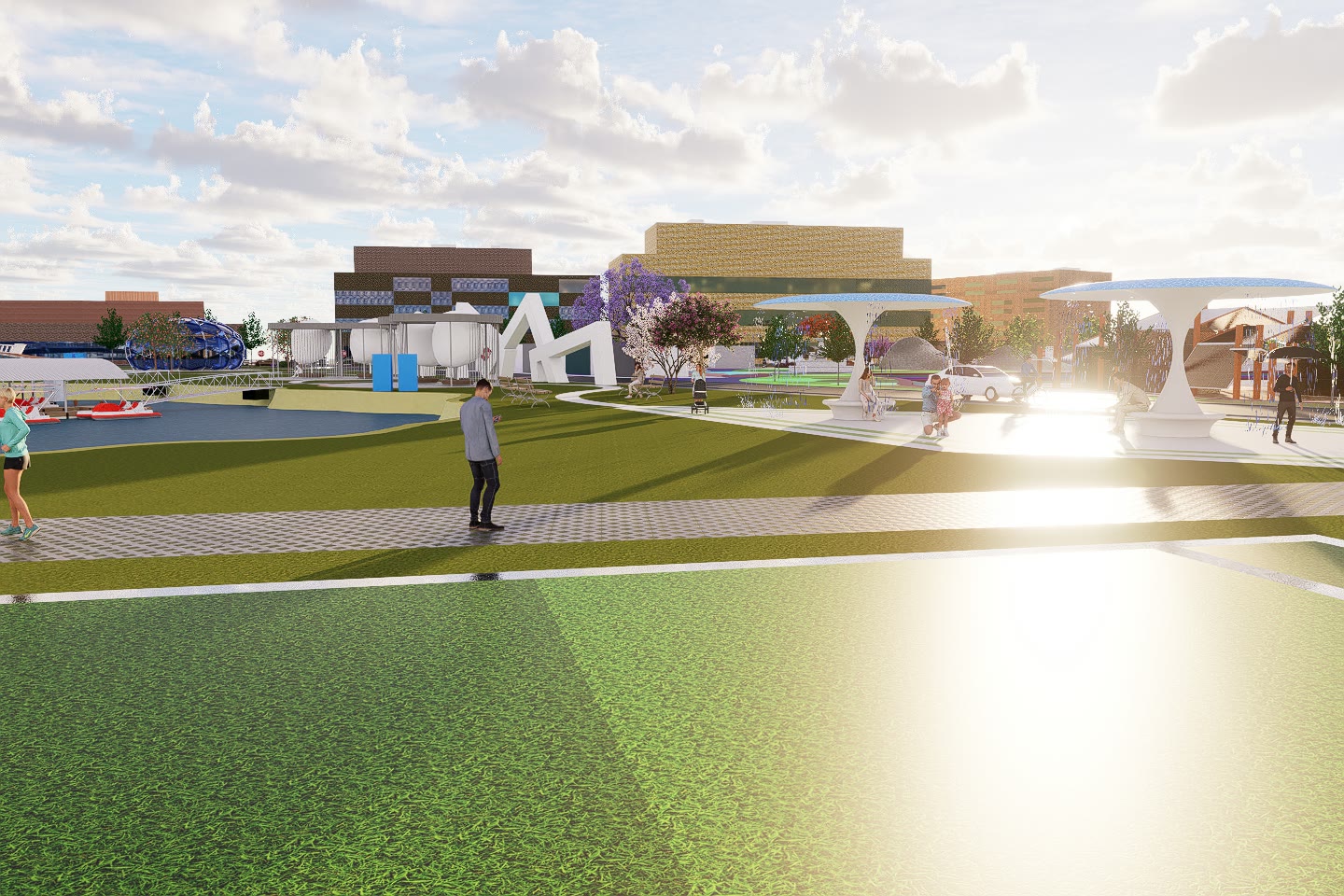 The playing field at sunset, the white canopy structures and the district buildings along the far edge